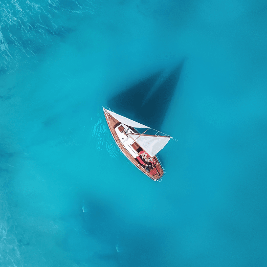 Yacht on the water surface from top view